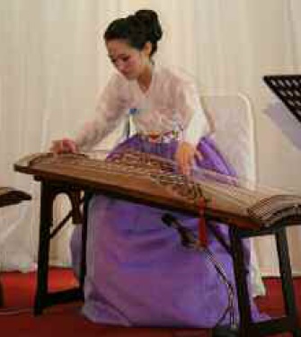 A performer from Hanyang University plays the gayageumam, a traditional Korean zither-like string instrument with 12 strings, during the opening ceremony for the conference.